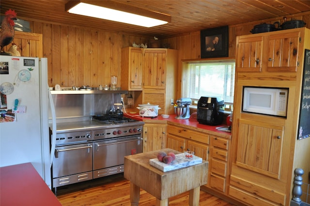 1876 Timber Creek Rd, Haugan, MT 59866 - kitchen featuring white appliances, wooden ceiling, wood walls, and light wood finished floors