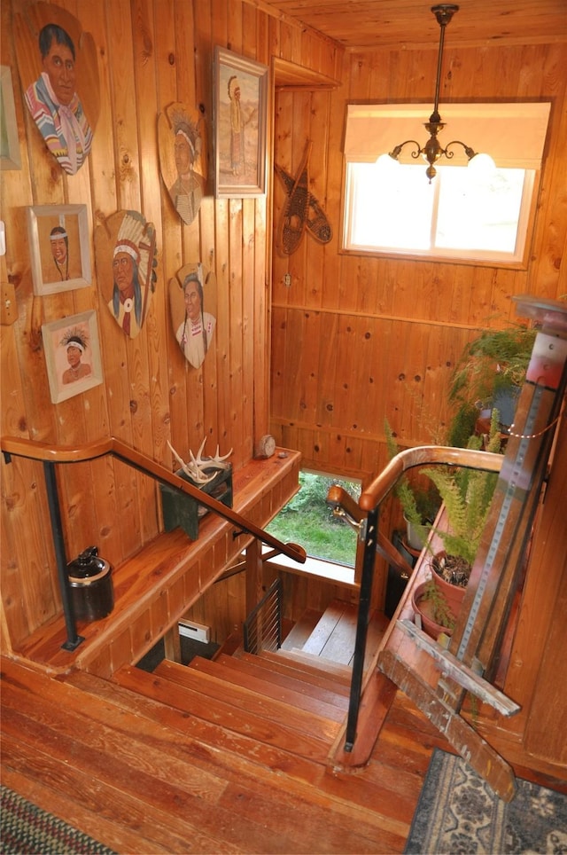 1876 Timber Creek Rd, Haugan, MT 59866 - stairway featuring hardwood / wood-style flooring, wooden walls, and a chandelier