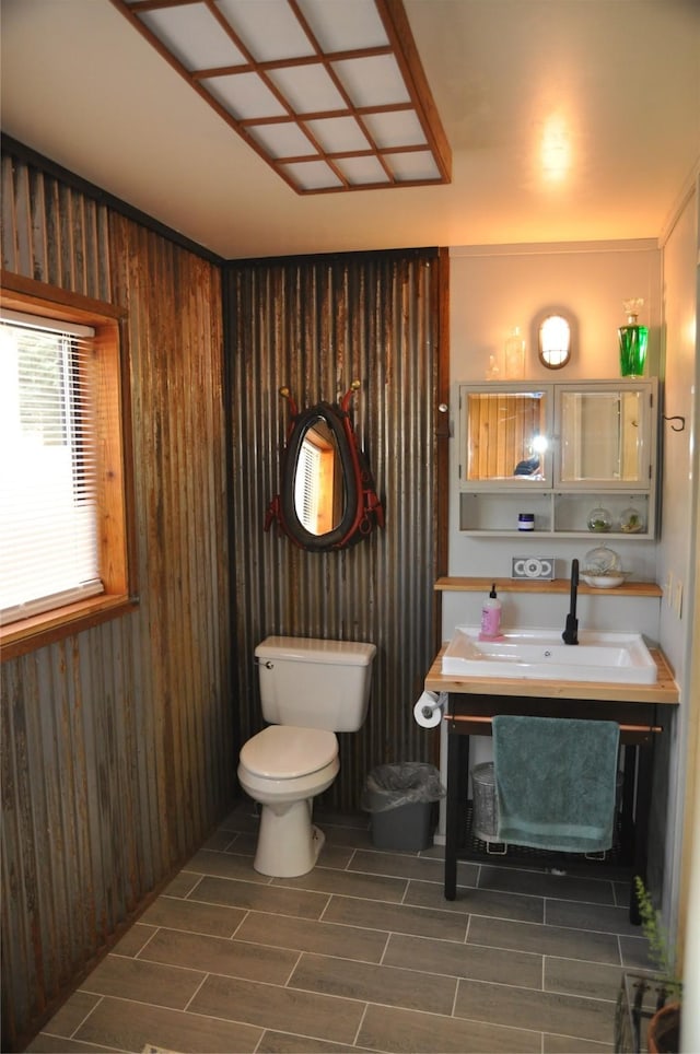 1876 Timber Creek Rd, Haugan, MT 59866 - half bathroom with wood finish floors, vanity, and wood walls