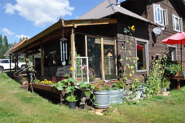 1876 Timber Creek Rd, Haugan, MT 59866 - view of property exterior featuring a lawn and a metal roof