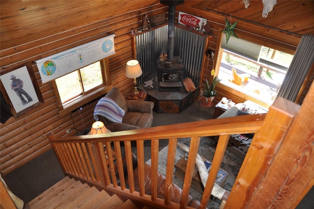 1876 Timber Creek Rd, Haugan, MT 59866 - living room with a wood stove, log walls, stairway, wood finished floors, and wood ceiling