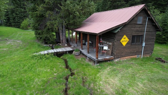1876 Timber Creek Rd, Haugan, MT 59866 - view of home's exterior featuring a yard, log exterior, and a metal roof