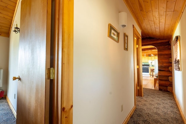 hall featuring wood ceiling, vaulted ceiling, and log walls