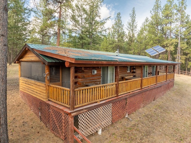 exterior space with a sunroom and a wooden deck