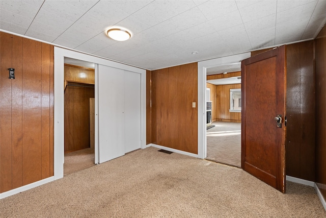 161 3rd Ave, Kalispell, MT 59901 - unfurnished bedroom with carpet flooring, wood walls, and a closet