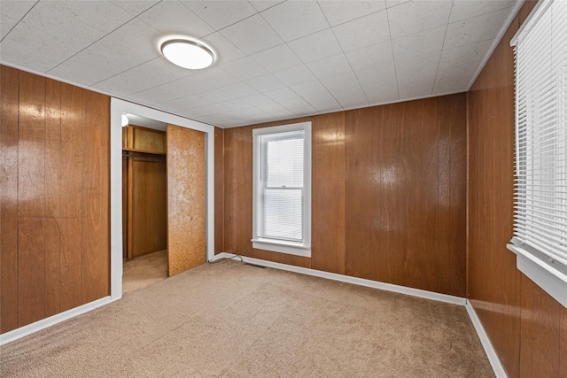 161 3rd Ave, Kalispell, MT 59901 - unfurnished bedroom with carpet, wooden walls, and a closet