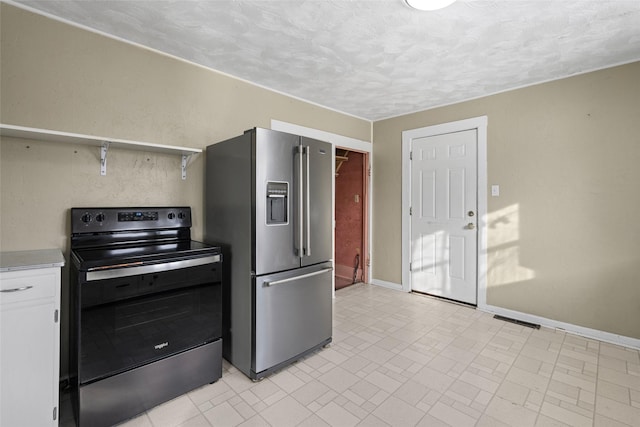 161 3rd Ave, Kalispell, MT 59901 - kitchen with high end refrigerator, black range with electric cooktop, light countertops, white cabinets, and a textured ceiling