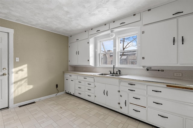 161 3rd Ave, Kalispell, MT 59901 - kitchen with light countertops, white cabinetry, and a textured ceiling
