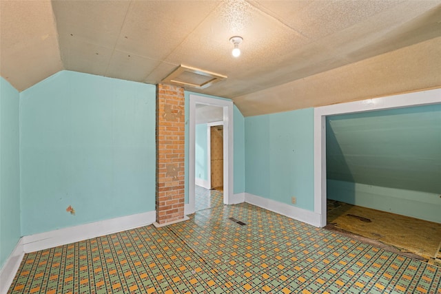 161 3rd Ave, Kalispell, MT 59901 - bonus room with attic access, lofted ceiling, and tile patterned floors