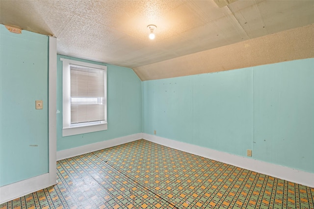 161 3rd Ave, Kalispell, MT 59901 - additional living space featuring vaulted ceiling and tile patterned floors