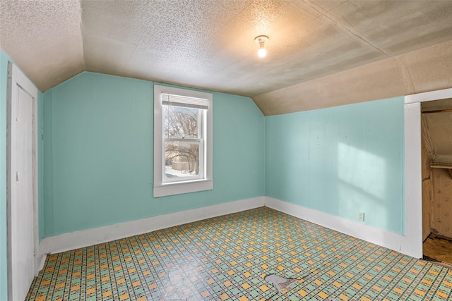 161 3rd Ave, Kalispell, MT 59901 - additional living space featuring lofted ceiling, tile patterned floors, and a textured ceiling