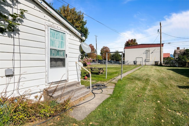 view of yard featuring fence and entry steps