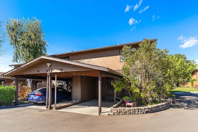 view of side of property featuring a carport