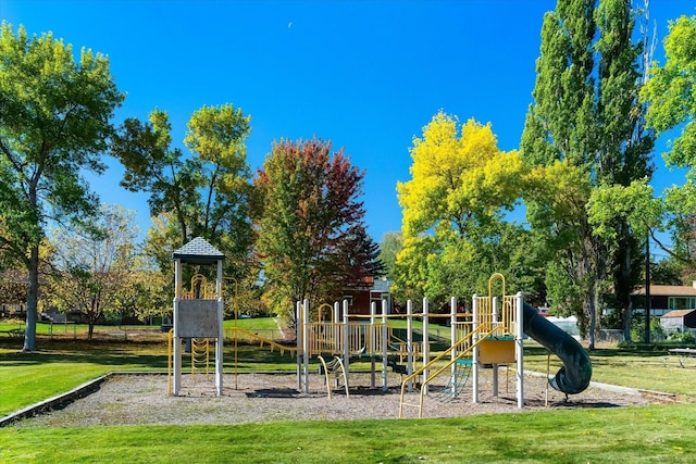 community jungle gym featuring a yard