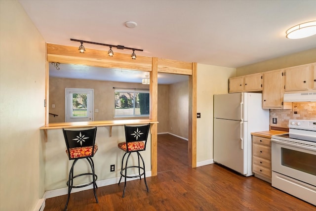 kitchen with tasteful backsplash, white appliances, dark wood-style flooring, under cabinet range hood, and a breakfast bar