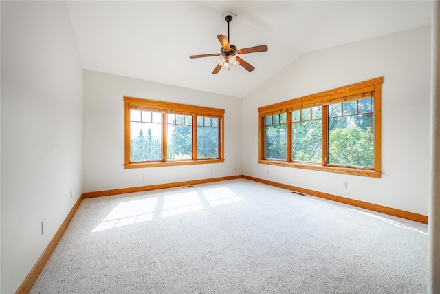 carpeted empty room featuring vaulted ceiling and ceiling fan