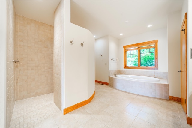 bathroom with tile patterned flooring and separate shower and tub