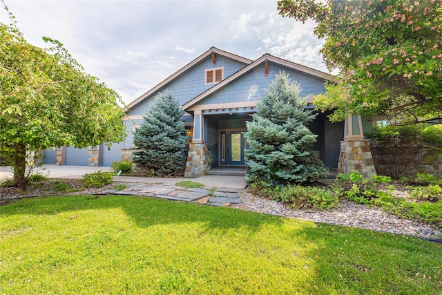 craftsman-style home with a front yard and a garage