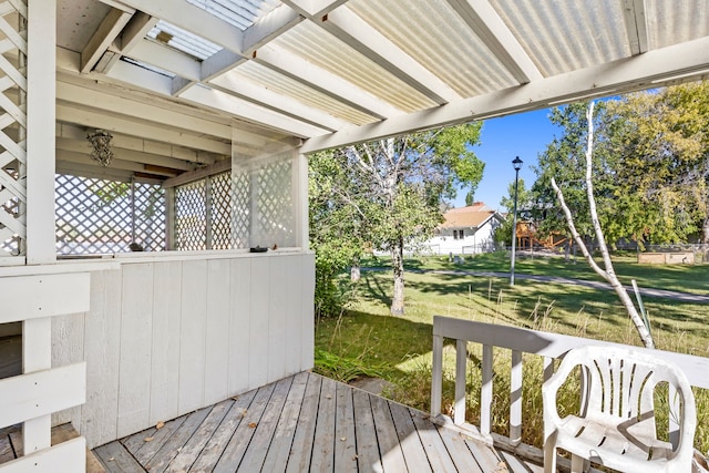 wooden terrace with a lawn