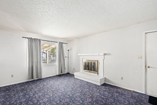 unfurnished living room with a textured ceiling and carpet floors