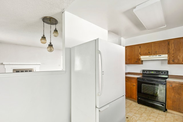 kitchen with black electric range oven, brown cabinets, under cabinet range hood, and freestanding refrigerator