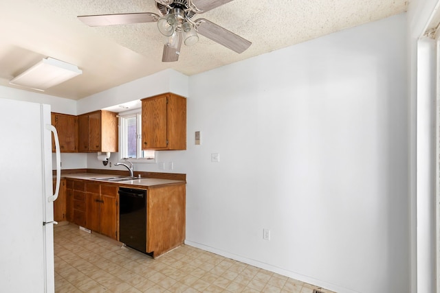 kitchen featuring ceiling fan, white refrigerator, sink, a textured ceiling, and dishwasher