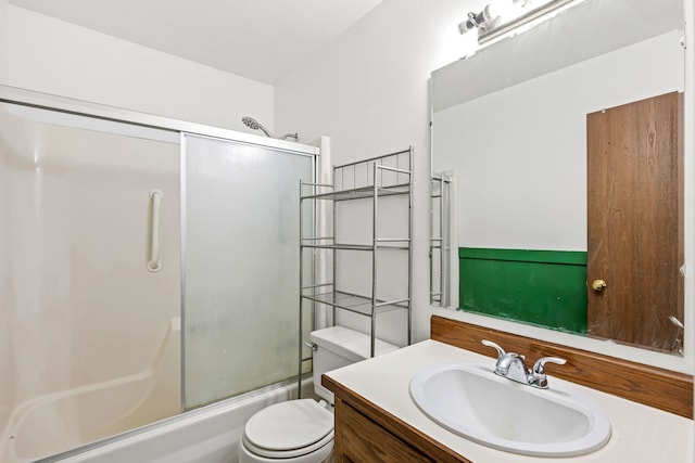 full bath featuring enclosed tub / shower combo, toilet, and vanity