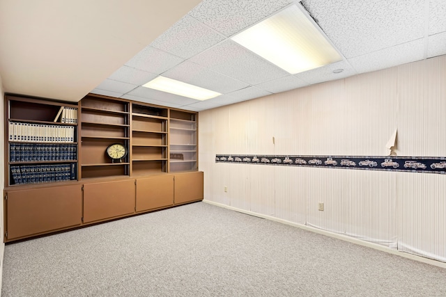 interior space featuring a drop ceiling and carpet floors