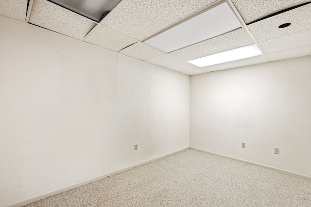 unfurnished room with a drop ceiling and carpet flooring