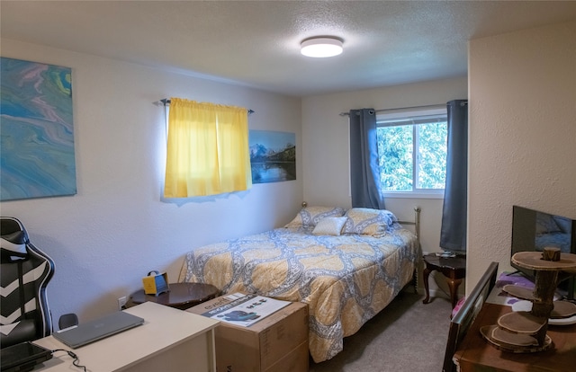 bedroom with a textured ceiling and carpet flooring