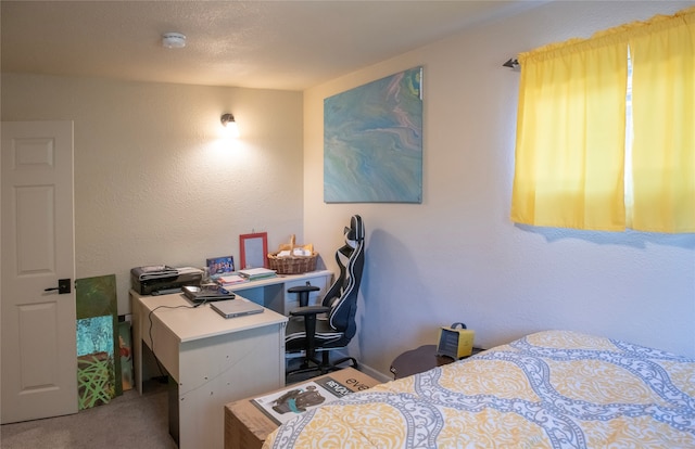 bedroom featuring a textured ceiling and carpet flooring