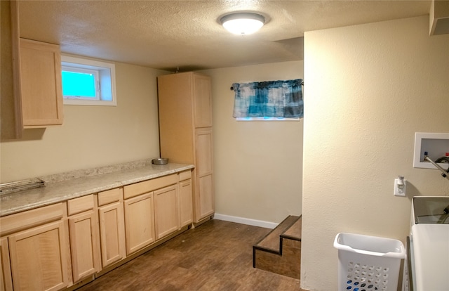 laundry room with hookup for a washing machine, cabinets, a textured ceiling, and dark hardwood / wood-style flooring