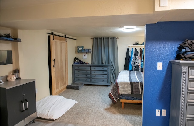 bedroom with light colored carpet and a barn door