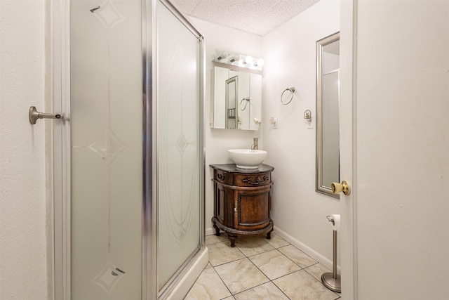 full bathroom with a shower stall, tile patterned floors, vanity, and baseboards