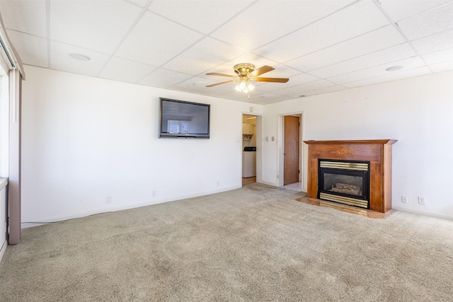 unfurnished living room featuring carpet flooring and a paneled ceiling