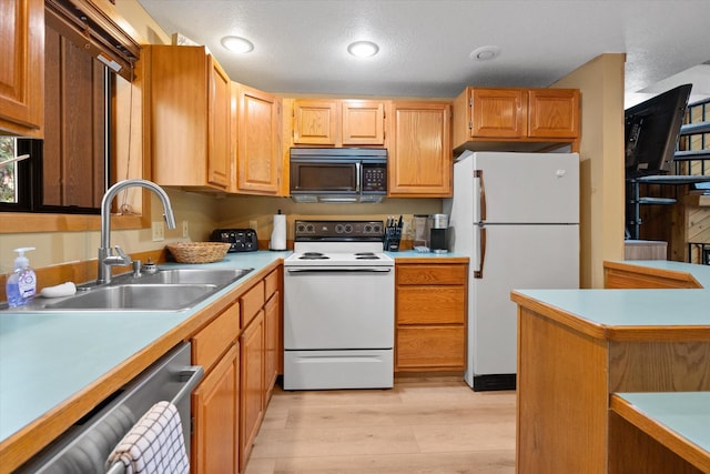 114 Cedar Way Unit 114, Whitefish, MT 59937 - kitchen with white appliances, light wood finished floors, and light countertops