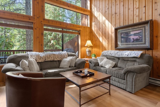 114 Cedar Way Unit 114, Whitefish, MT 59937 - living room with wood finished floors, wooden walls, and a baseboard heating unit