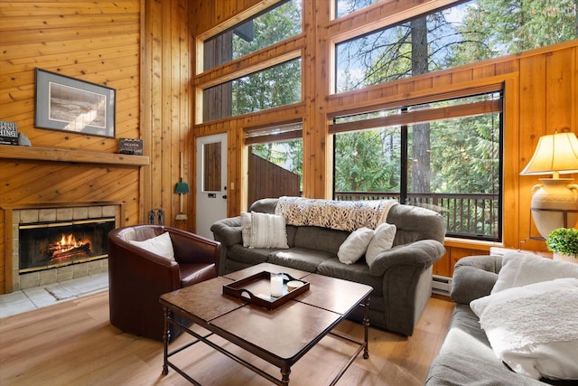 114 Cedar Way Unit 114, Whitefish, MT 59937 - living area with wood walls, plenty of natural light, a towering ceiling, a fireplace, and wood finished floors