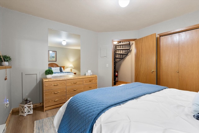 114 Cedar Way Unit 114, Whitefish, MT 59937 - bedroom featuring light wood-style floors, a closet, and a baseboard radiator