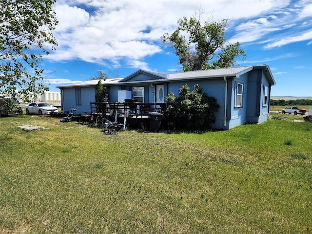 rear view of property featuring a yard