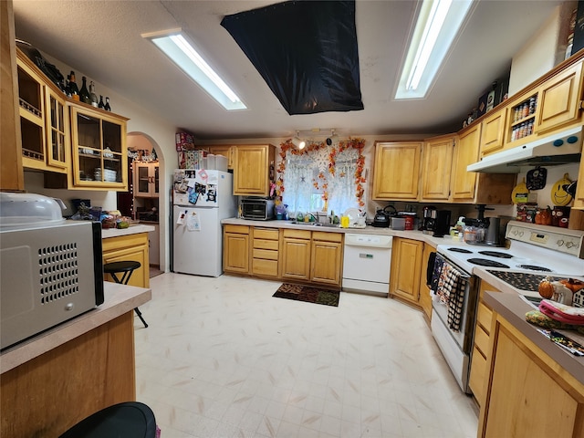 kitchen featuring white appliances and sink