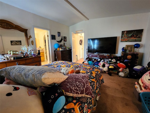 carpeted bedroom with vaulted ceiling and ensuite bathroom