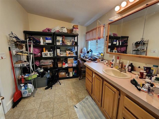 bathroom with vanity and a textured ceiling