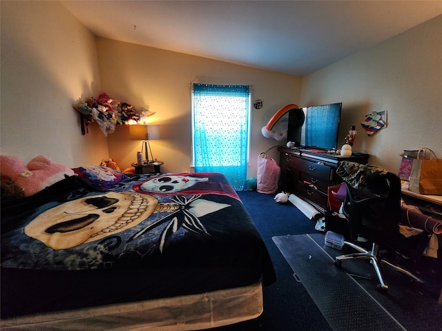 bedroom with dark colored carpet and vaulted ceiling