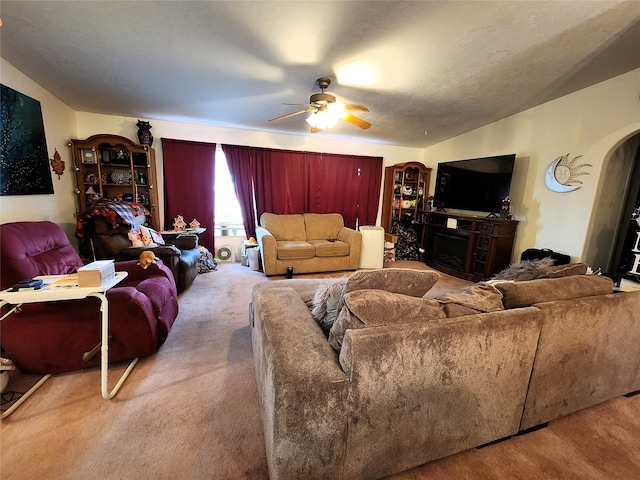 living room featuring ceiling fan, vaulted ceiling, and carpet