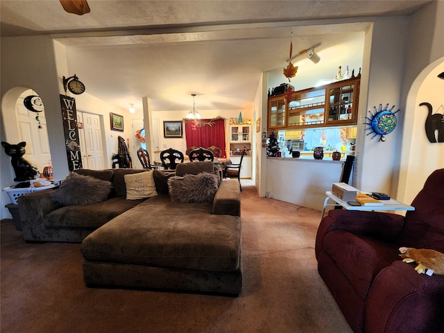 living room with carpet floors, lofted ceiling, and ceiling fan