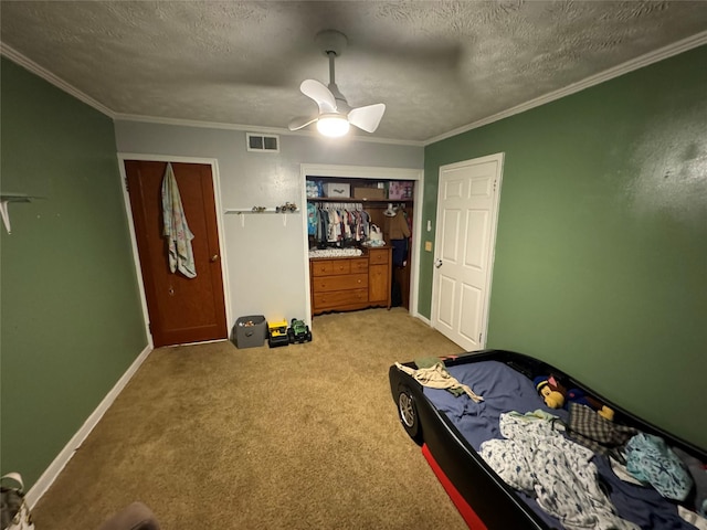 bedroom featuring crown molding, a textured ceiling, visible vents, and light carpet
