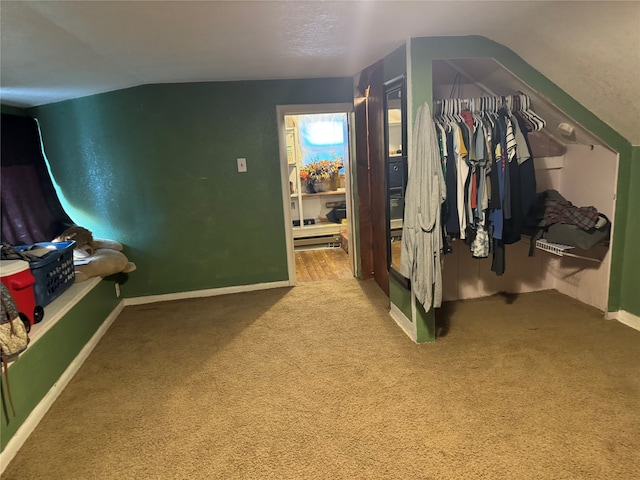 carpeted bedroom featuring vaulted ceiling and a closet