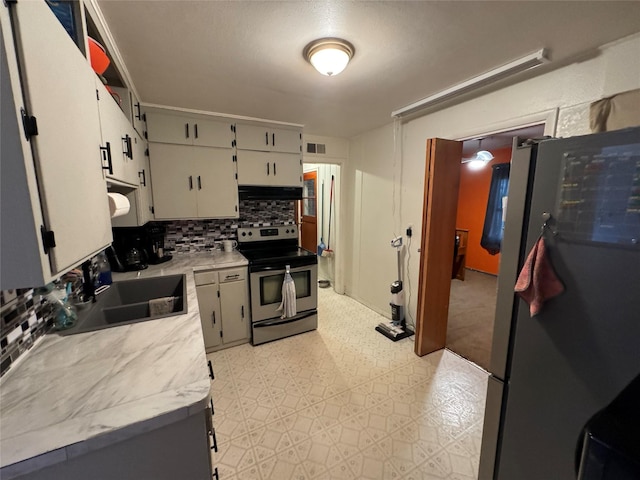 kitchen featuring a sink, light countertops, stainless steel appliances, decorative backsplash, and visible vents
