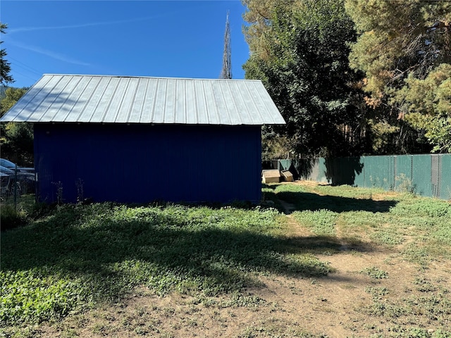 exterior space featuring fence, an outdoor structure, and a storage shed